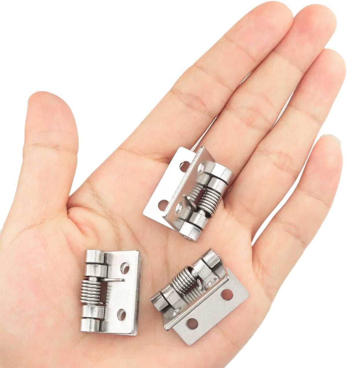 Spring-loaded self-closing hinge, small iron push-pull latch held in a hand for scale
