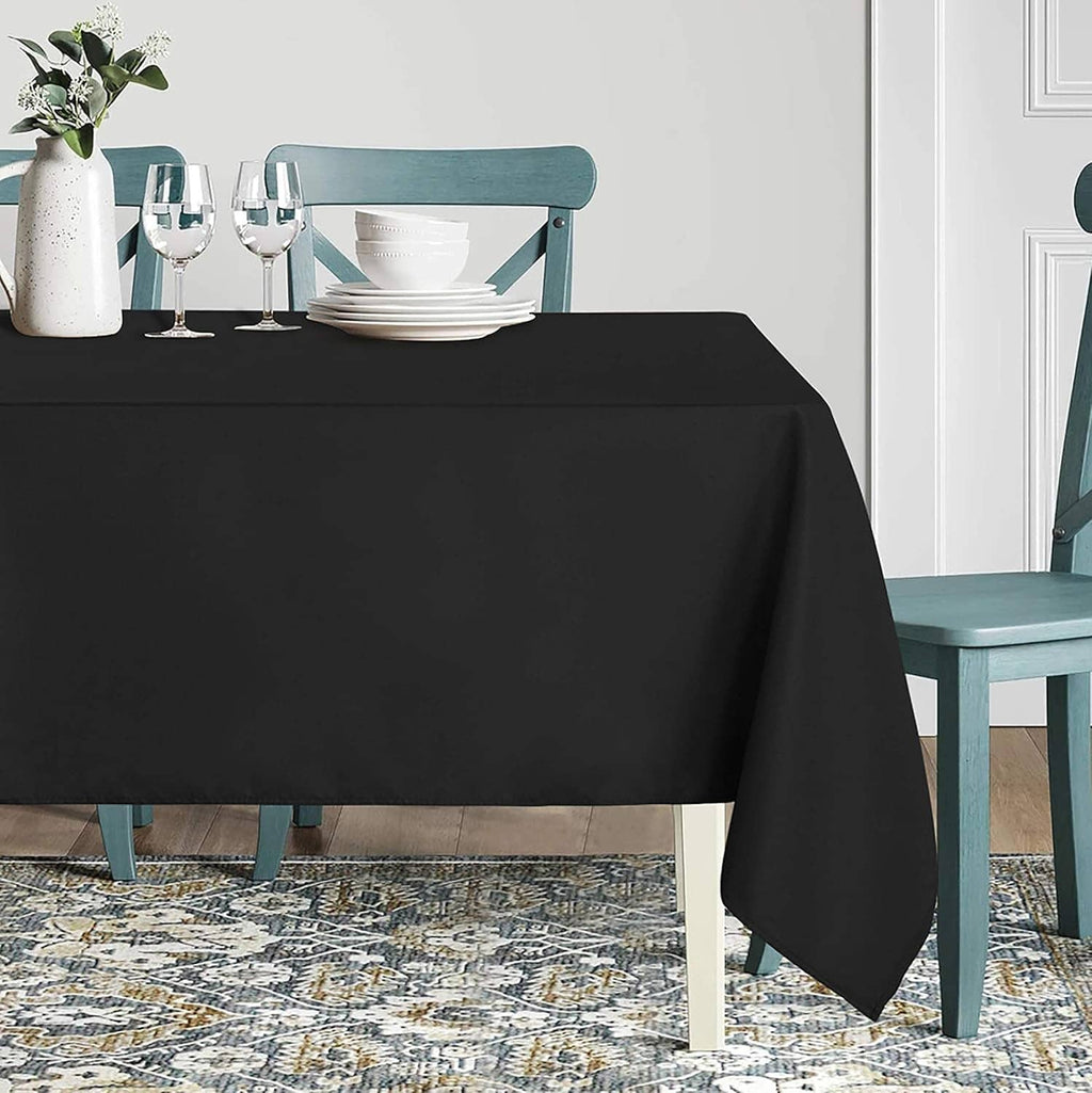 Black rectangular tablecloth on table, wrinkle-resistant smooth drape