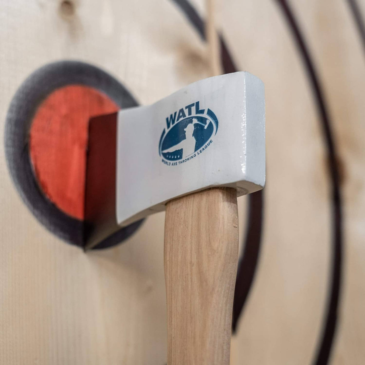 WATL-logo axe head on wooden handle with angled white blade