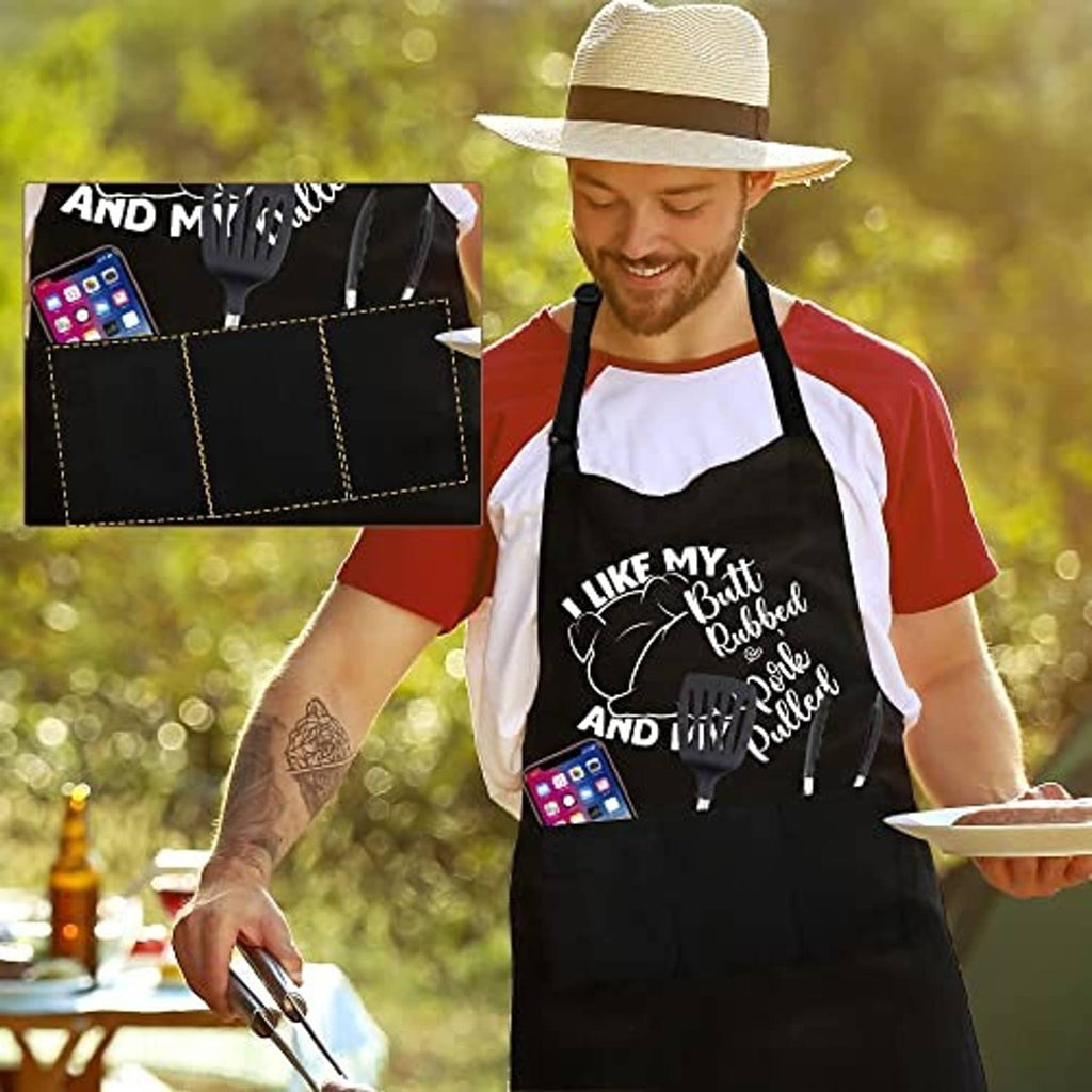 Black barbecue apron on man wearing hat, humorous butt-rubbed text with utensil graphics