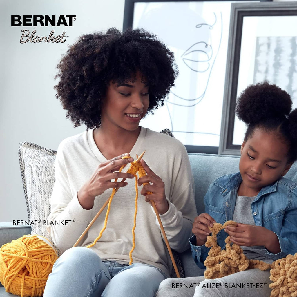 Chunky yarn balls and crochet project in progress held by a parent and child