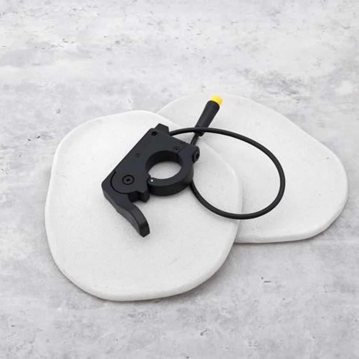 Electric bike thumb throttle controller with round clamp, black lead, and yellow-tipped plug
