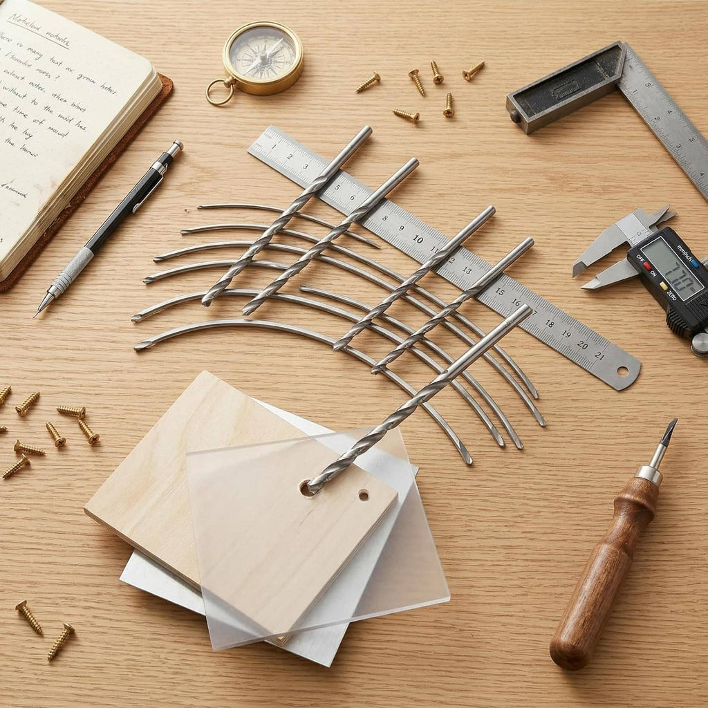 Long spiral twist drill bits spread on a wooden work surface