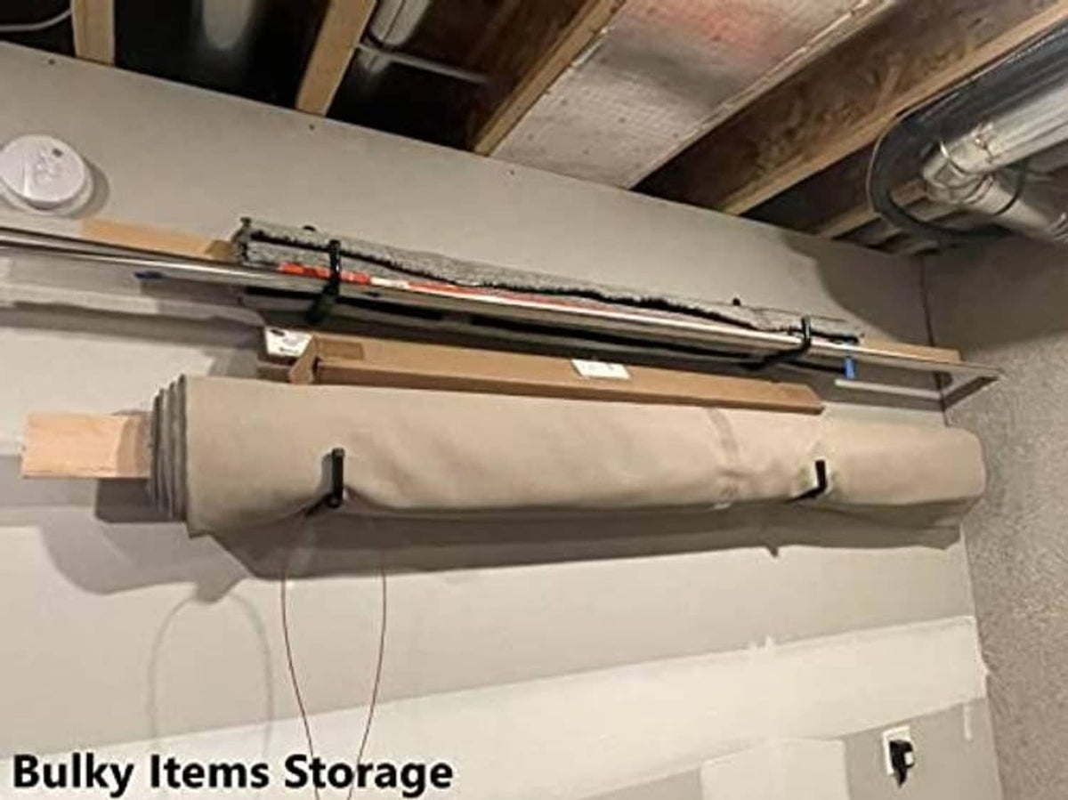 Black U-shaped wall hook holding a rolled-up bulky item on a garage wall
