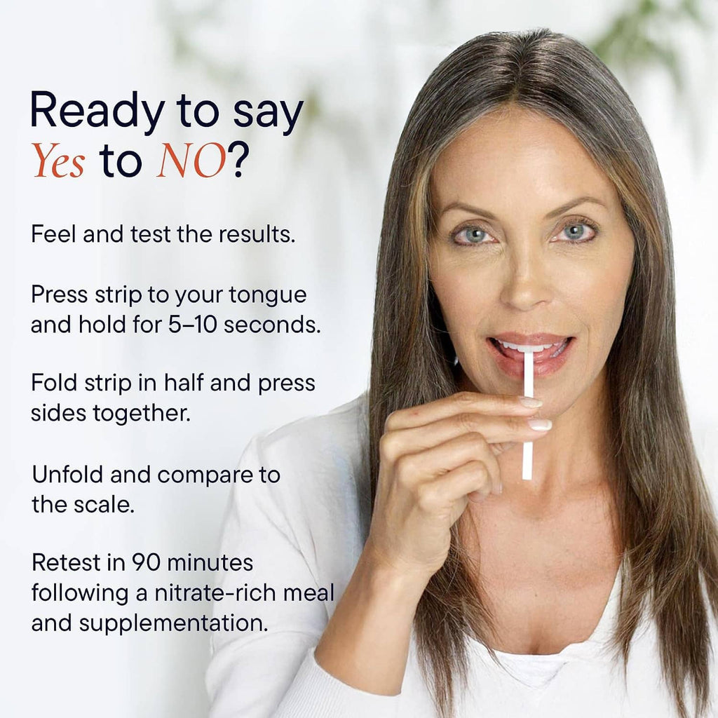 Woman holding a nitric oxide indicator test strip at her tongue for saliva testing