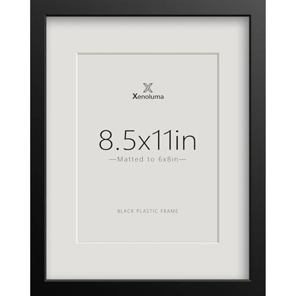 Black plastic picture frame with white mat, centered 8.5x11 display.