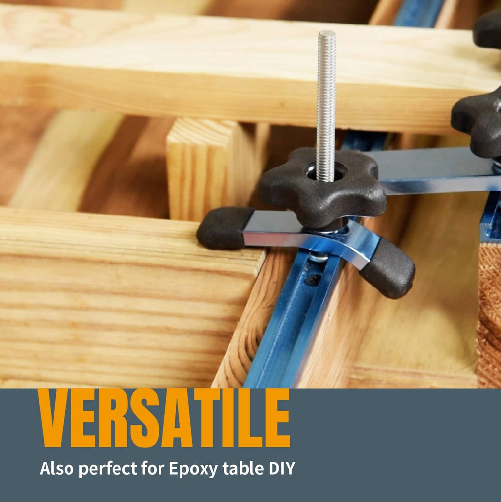 Blue T-track hold-down clamp with black handles clamping a wooden board