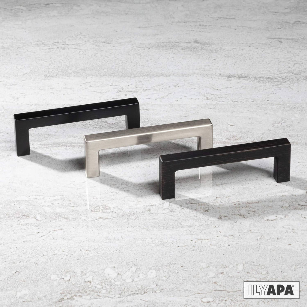 Multiple square cabinet pulls in matte black and satin finish on display