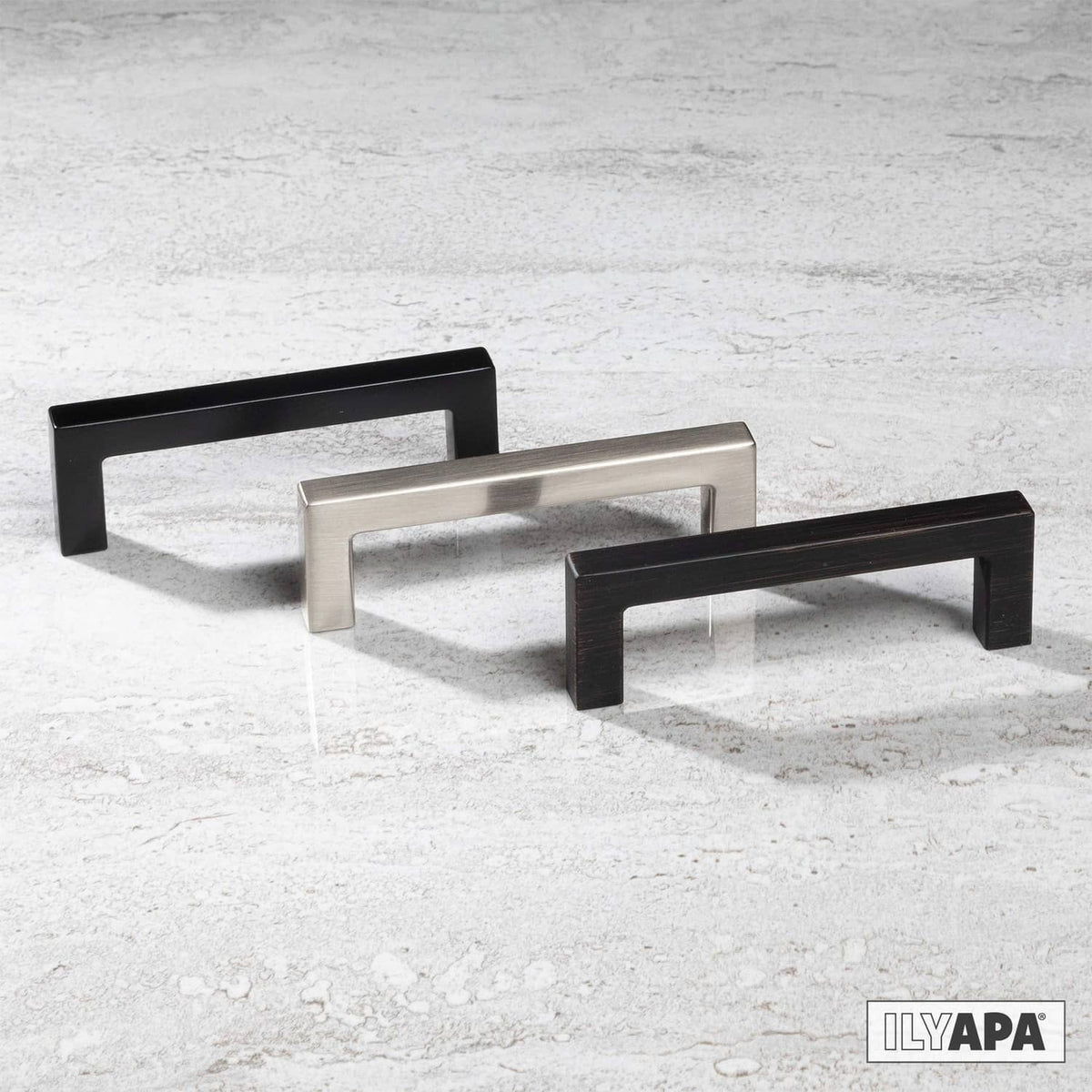 Multiple square cabinet pulls in matte black and satin finish on display