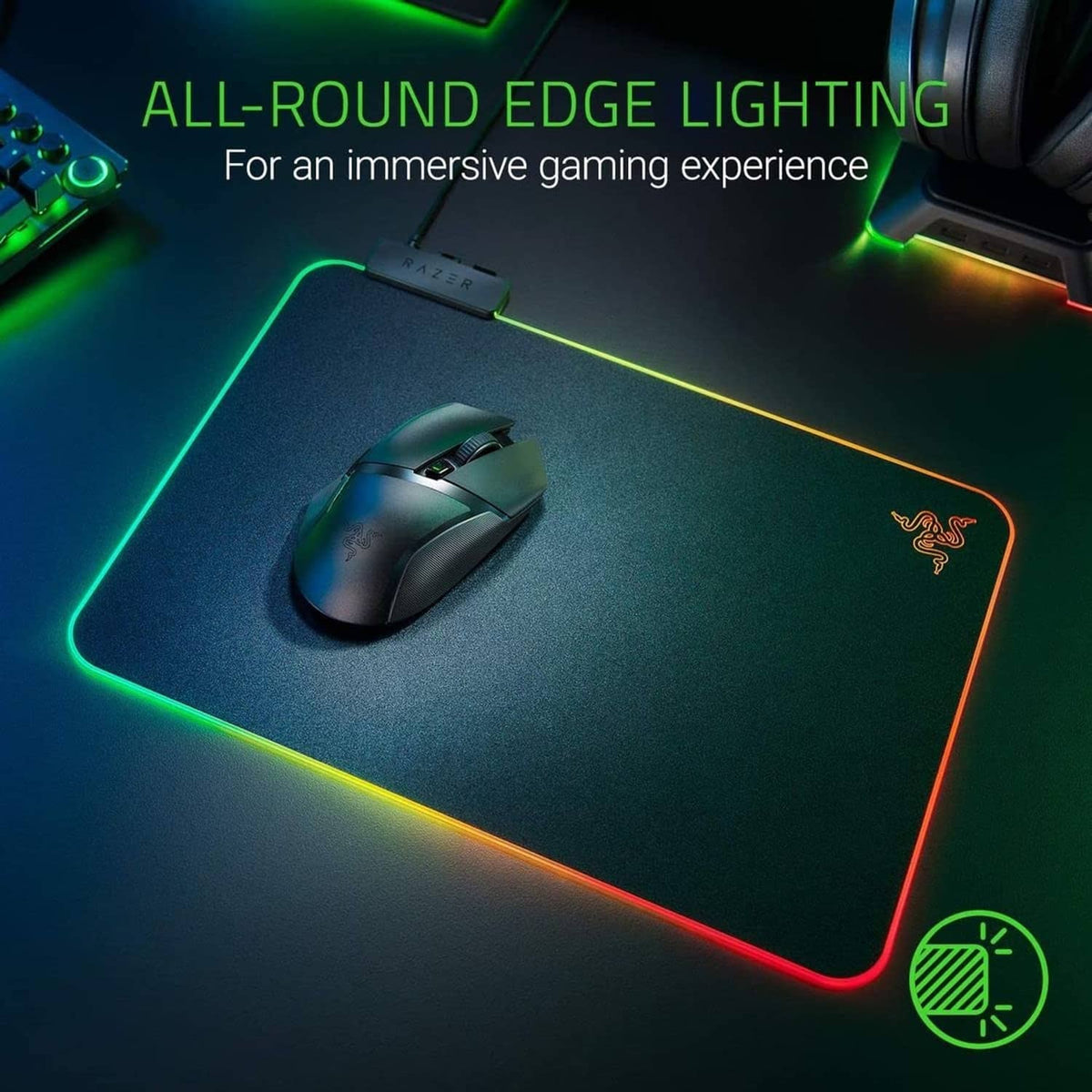 RGB edge-lit gaming mouse pad with Razer logo and mouse resting on hard surface