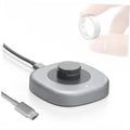 Dark gray smart ring charging dock with central contact and attached charging cable