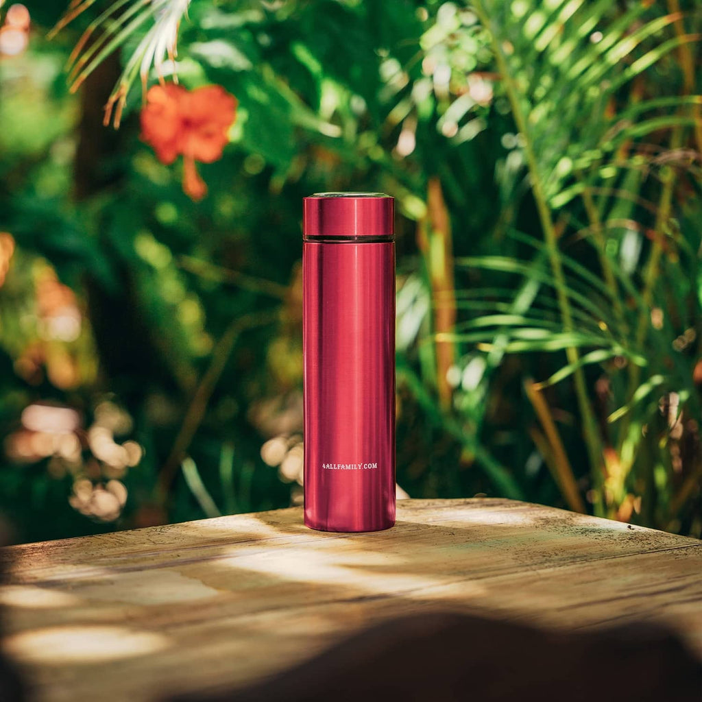 Red insulated insulin cooler case standing upright outdoors on wood