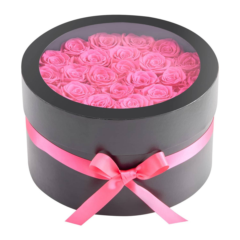 Round preserved rose bouquet in gray box with pink bow and pink roses visible
