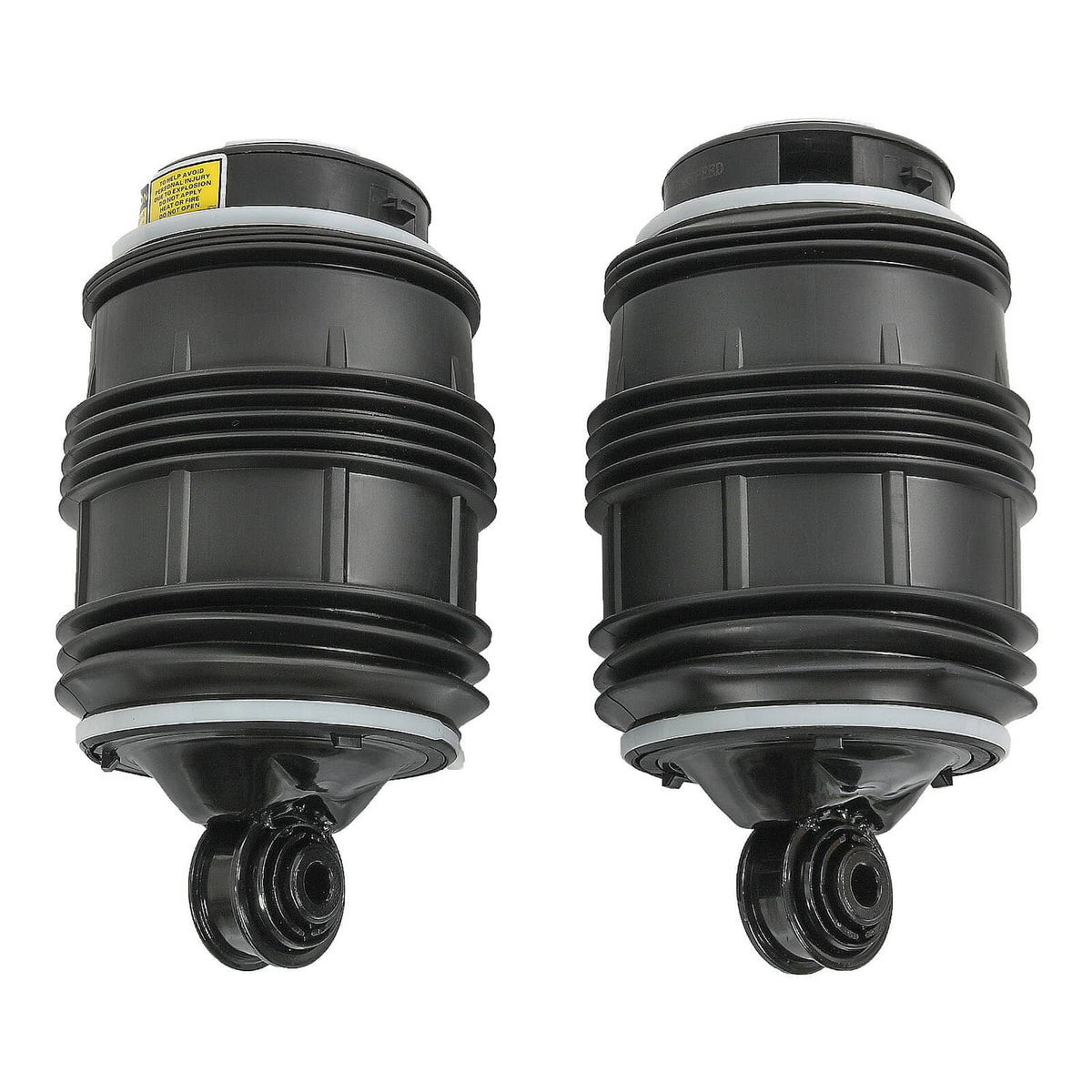Pair of black rear air suspension springs, one shows a yellow warning sticker.
