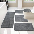 Five-piece dark grey bath rug set with pebble-texture mats and round toilet lid cover