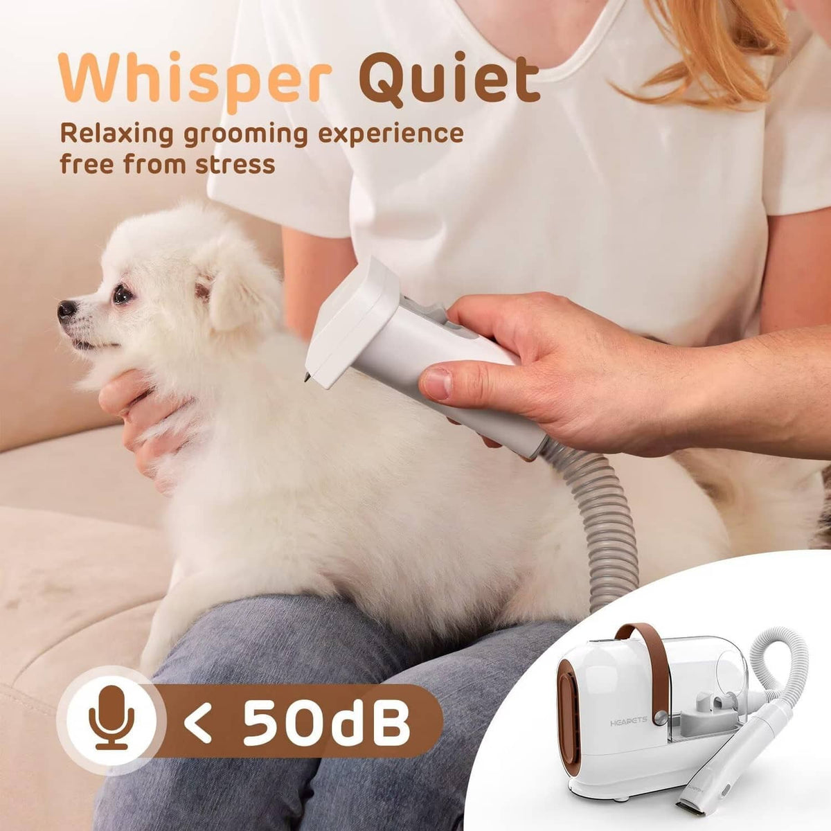 Quiet pet grooming vacuum handheld tool with hose for gentle grooming on a white dog