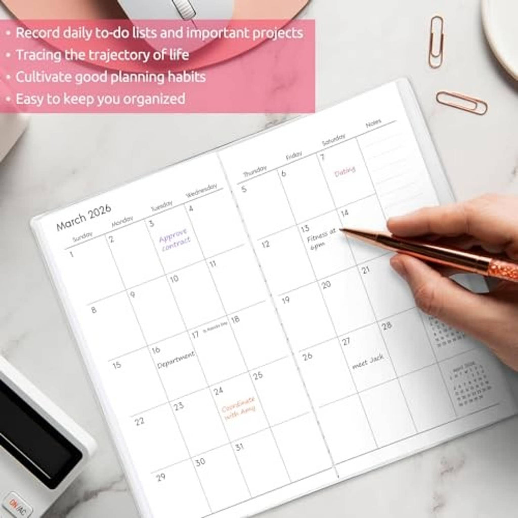 Pocket calendar planner with date grid; hand writing notes with a pen
