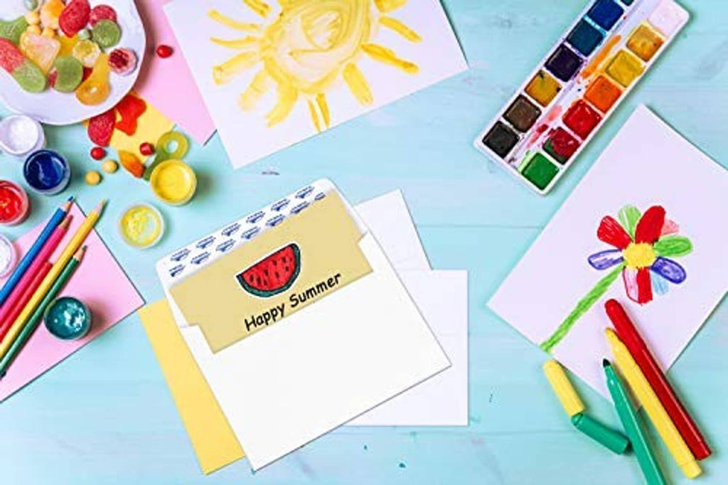 White A7 invitation envelopes with seal strip, on colorful craft table