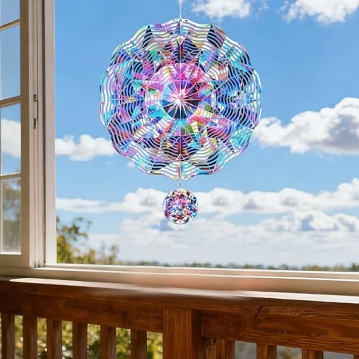 Rainbow 3D metal wind spinner pinwheel with hanging mini disc, hanging on a porch