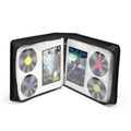 Black DVD storage case opened, holding discs and booklets in clear sleeves