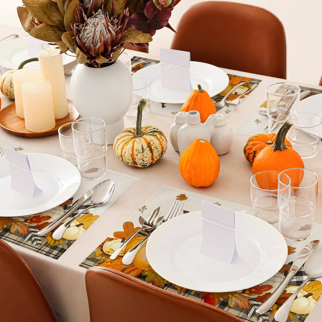 Beige placemat with orange pumpkin and leaf print, plaid corner accents