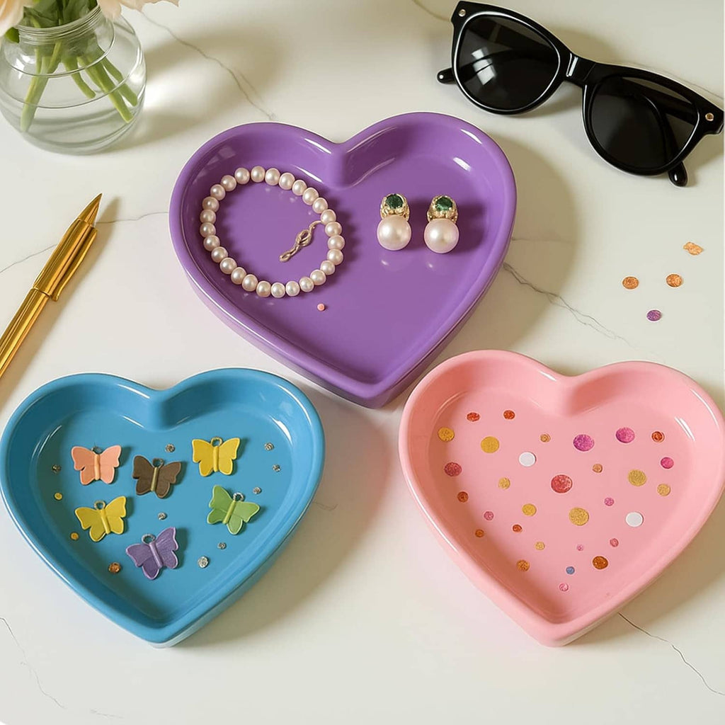 Heart-shaped resin trays in purple and pink with pearl jewelry and small charm accents