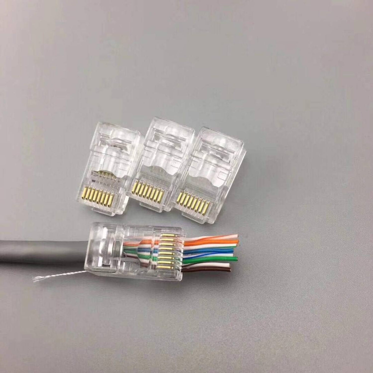 RJ45 pass-through connectors with clear housings and a multi-wire cable