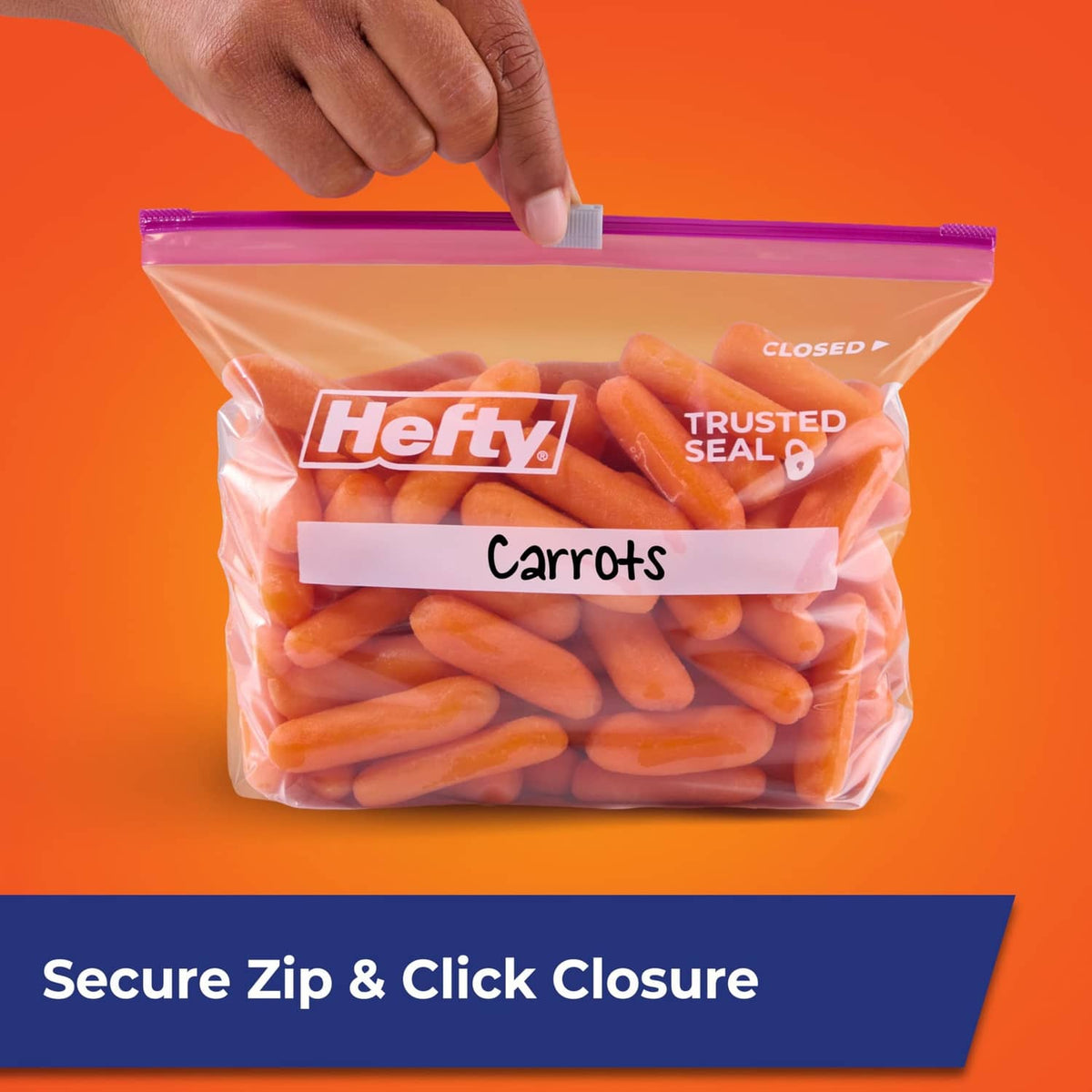 Hand holding a closed quart slider storage bag with carrots and secure zip closure