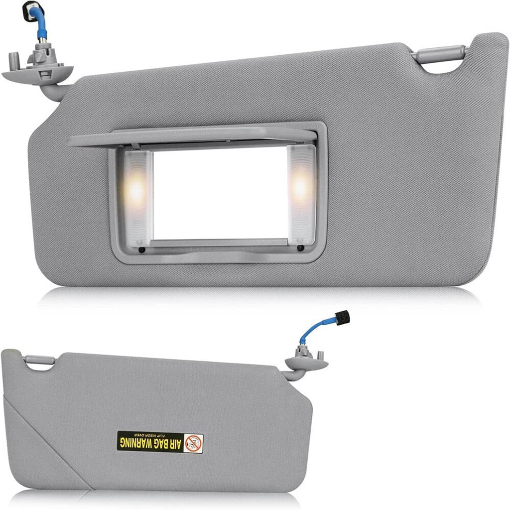 Gray textured car sun visor with LED light panel opening and warning label on side