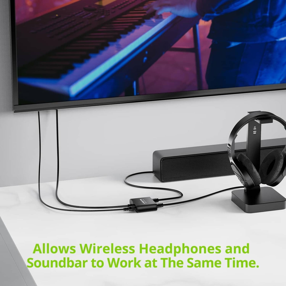 Optical audio splitter with connected cable on desk near monitor setup
