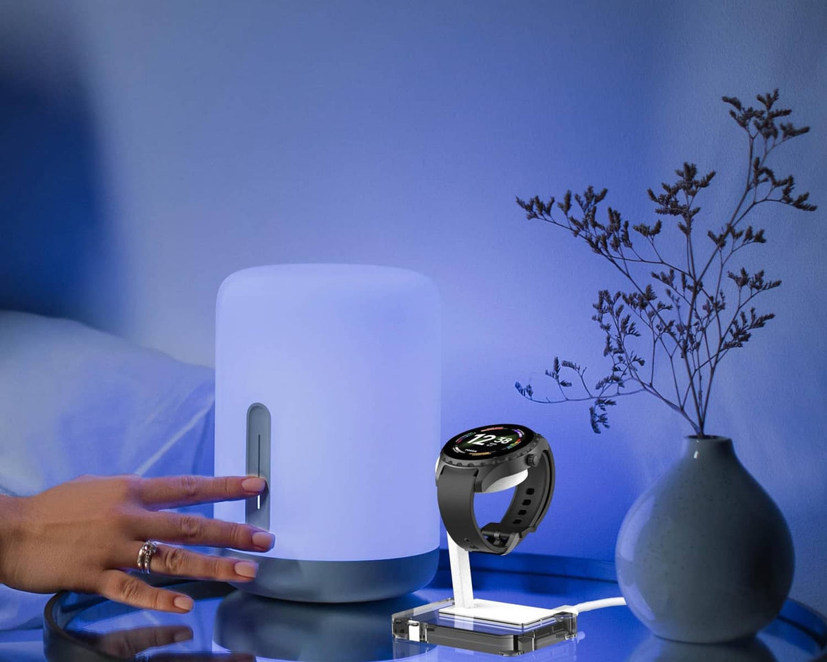 White smartwatch charging stand with clear base and watch dock, 4-pin design.