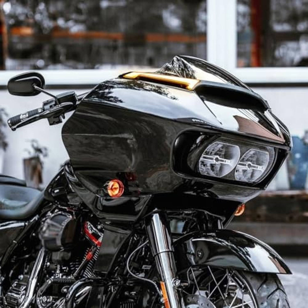 Installed LED windshield trim lights on motorcycle with black housing, amber glow