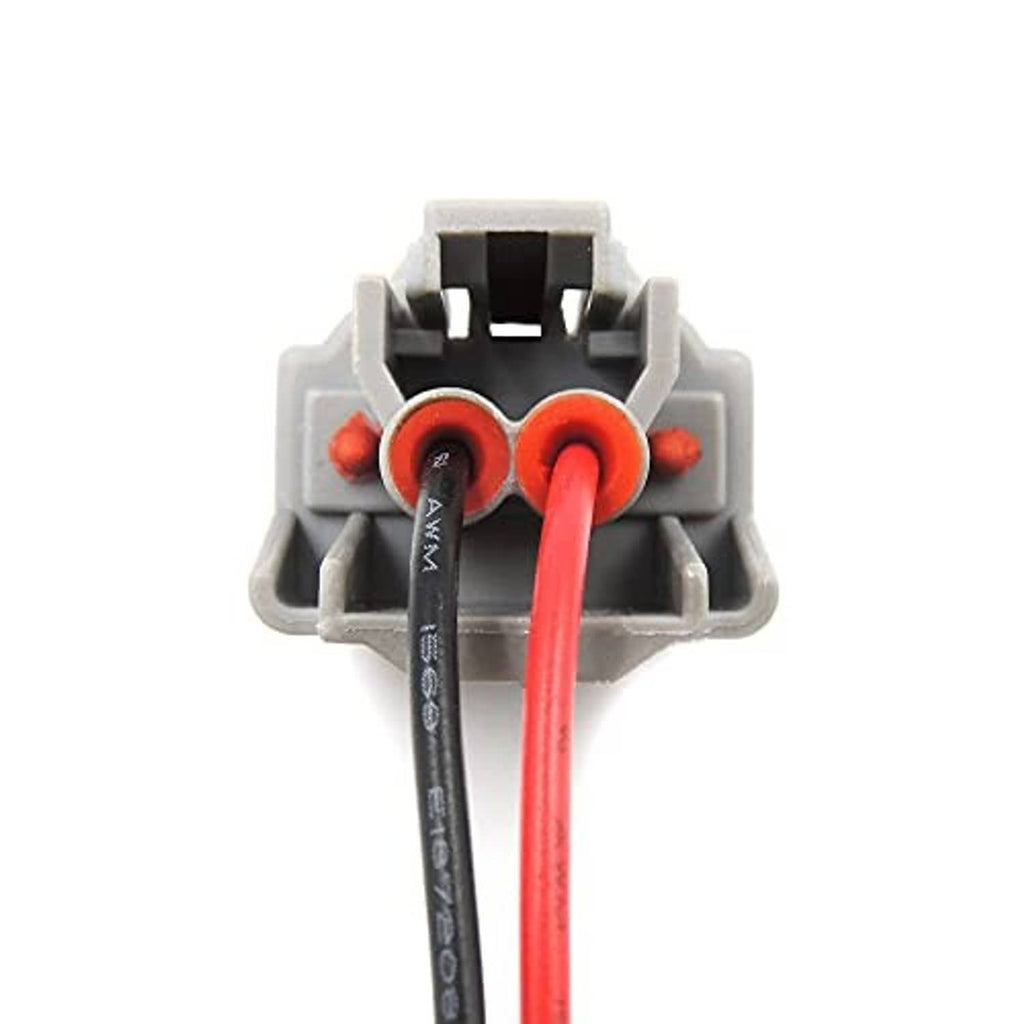 Close-up of fuel injector connector terminals with red wire and black wire