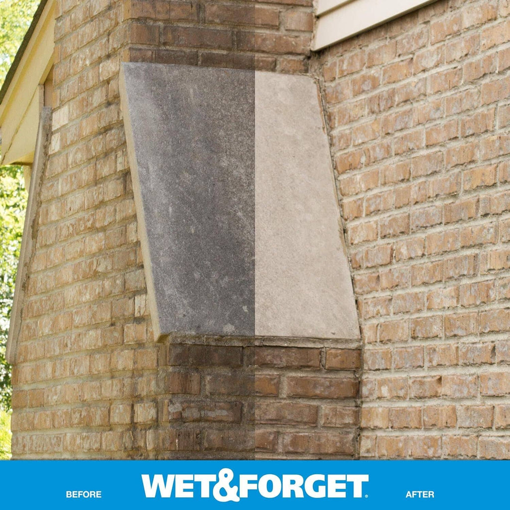 Brick wall corner with a cleaned square area showing reduced grime and stains