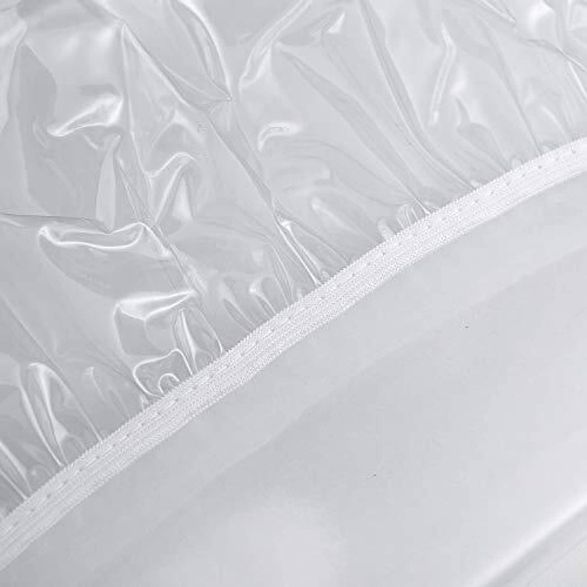 Transparent plastic table cover edge with white stitched hem detail