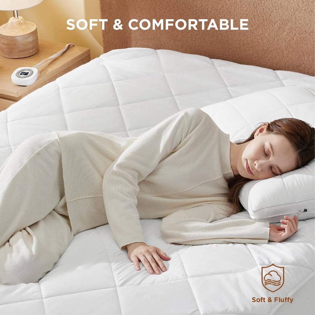 White heated mattress pad on bed with wireless controller and soft quilted top