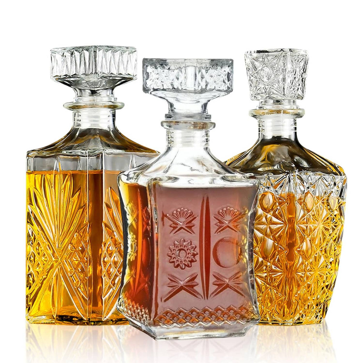 Three-piece crystal whiskey decanter set: clear and amber bottles with faceted sides