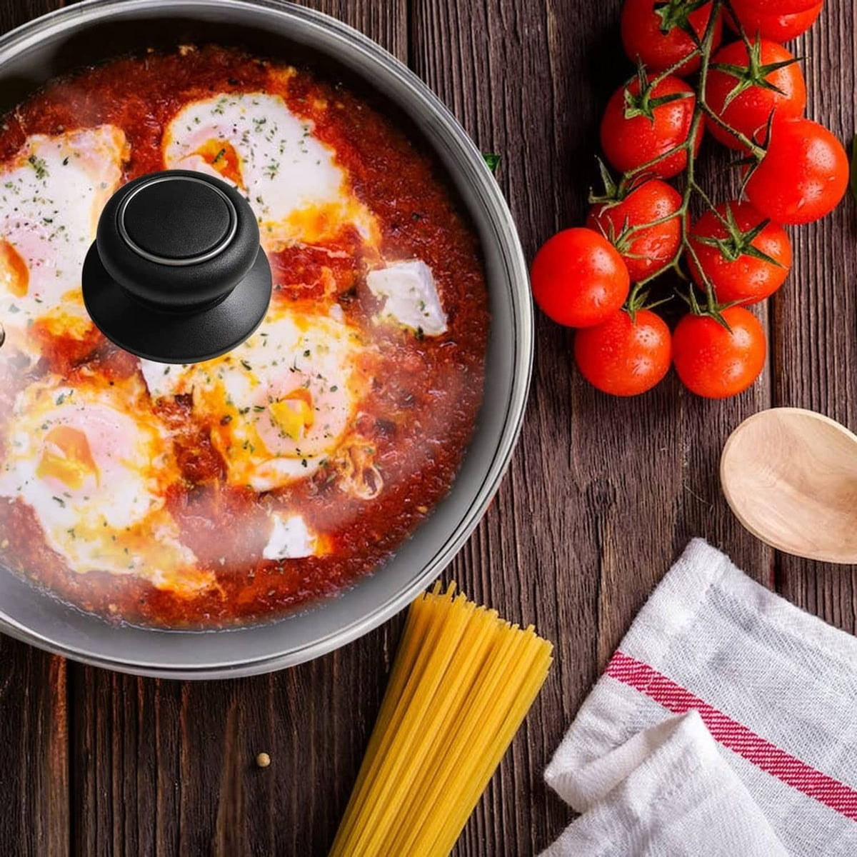 Black pot lid replacement knob on a covered skillet with cooked food inside
