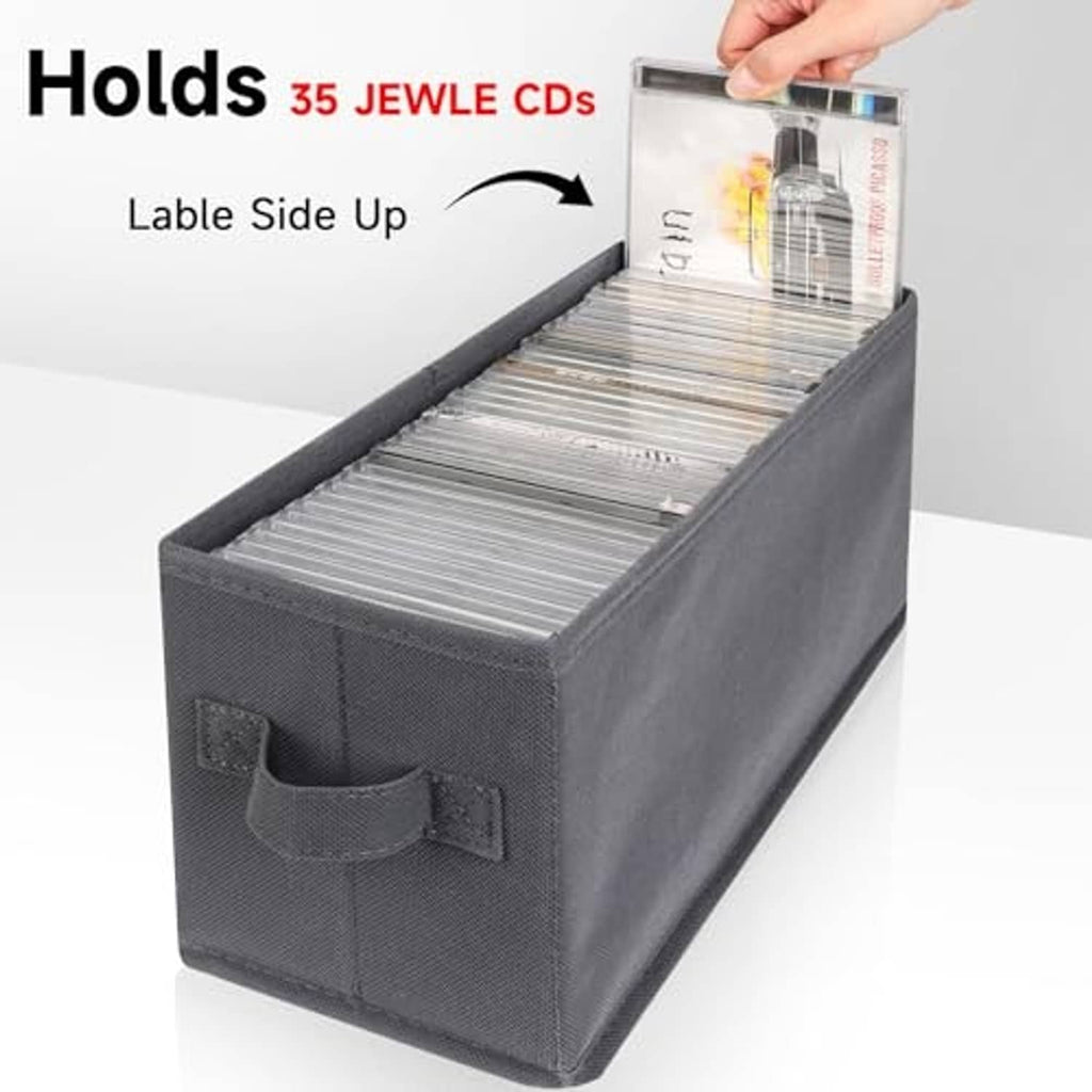 Gray CD storage box with open lid and disc holder pocket, hand placing a CD