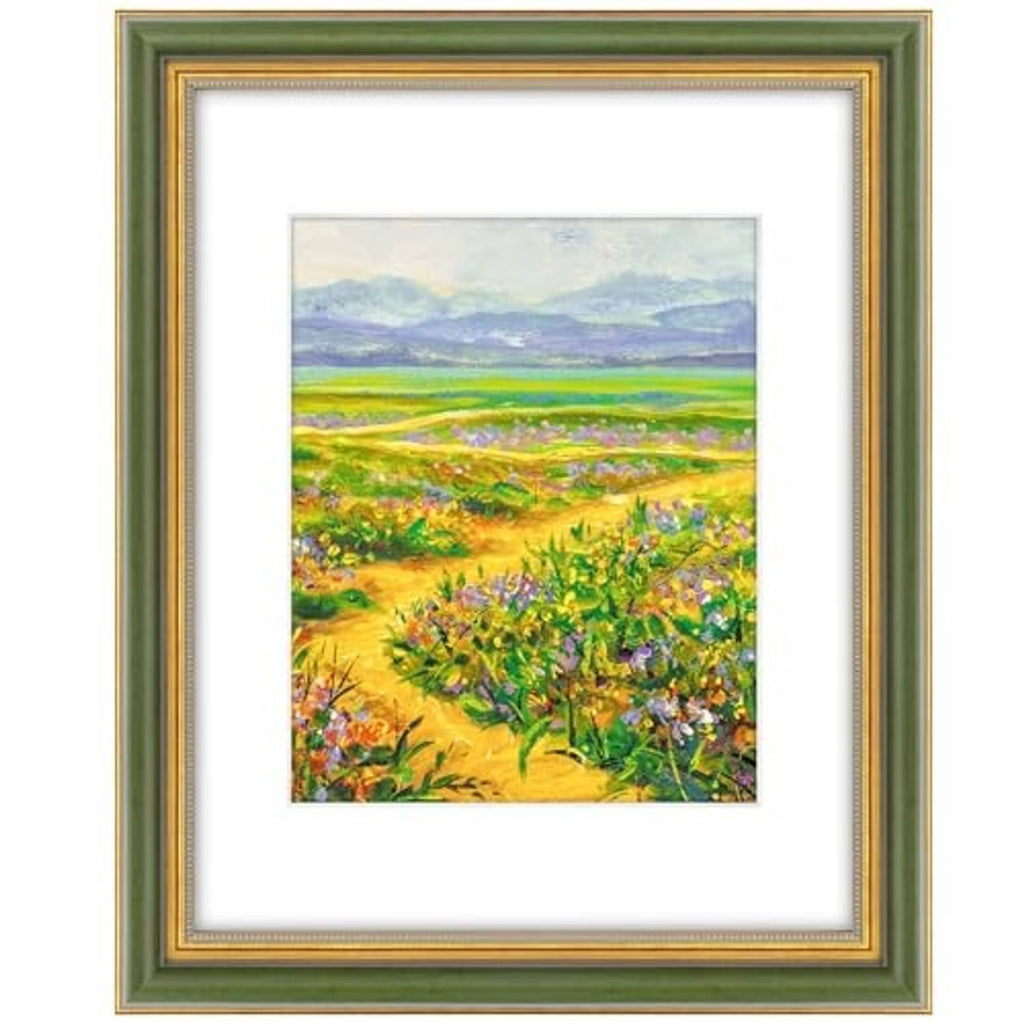 Ornate green and gold picture frame with white mat, showing a landscape print.