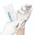 White cotton moisturizing gloves shown on hands, long sleeve and finger coverage