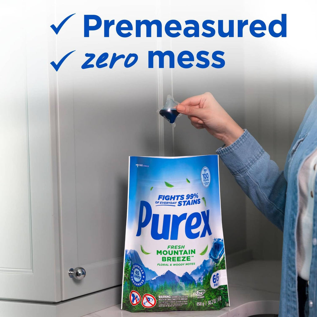 Purex Fresh Mountain Breeze detergent pouch held by hand near washer door