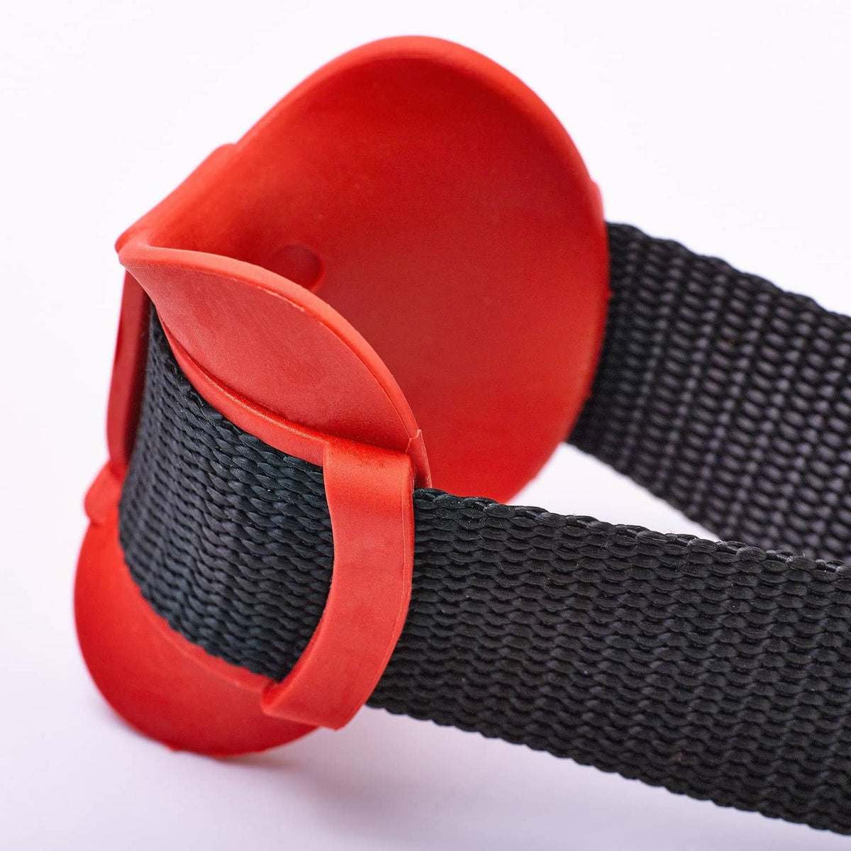 Door anchor end with red cap over textured black strap