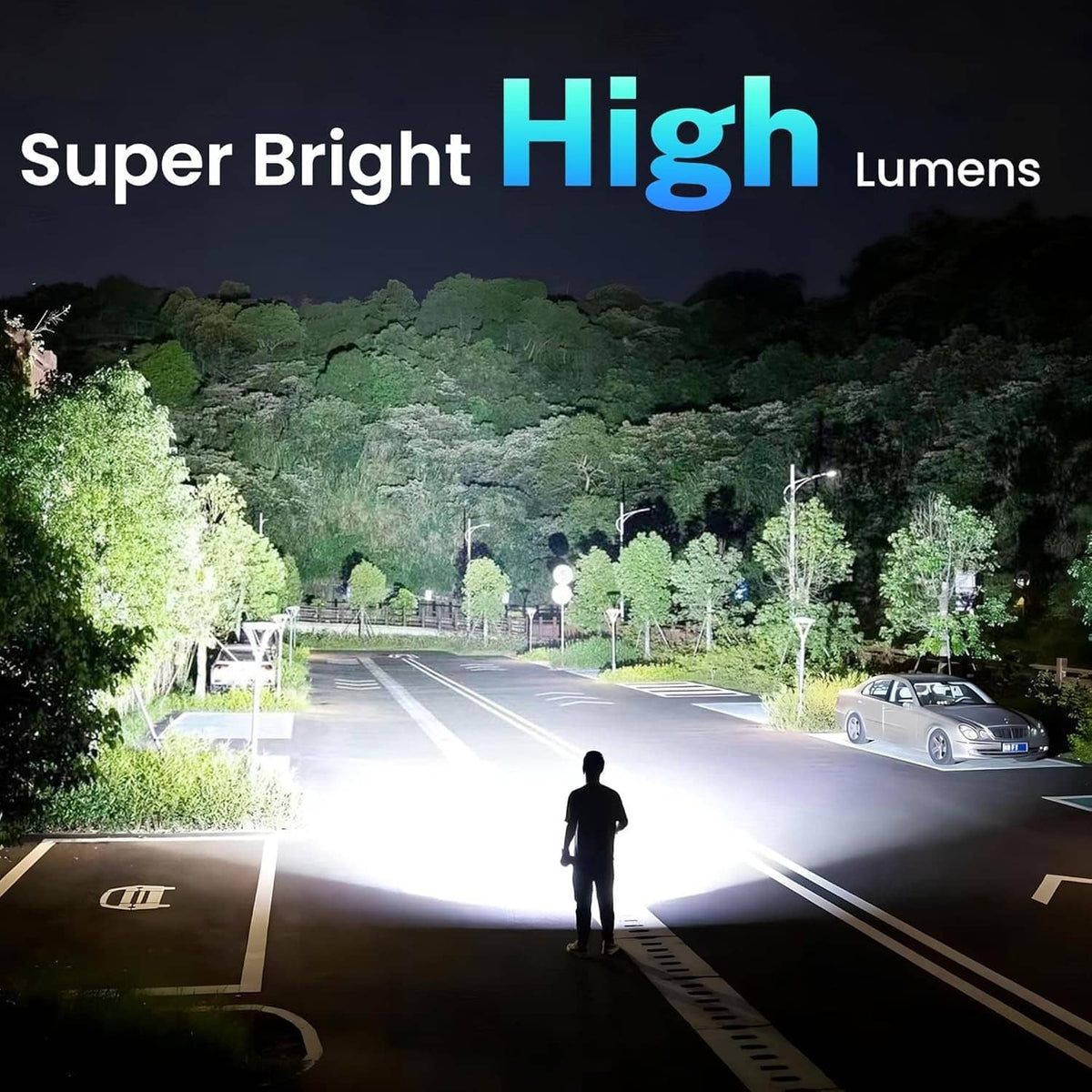 Black rechargeable flashlight casting bright beam on road