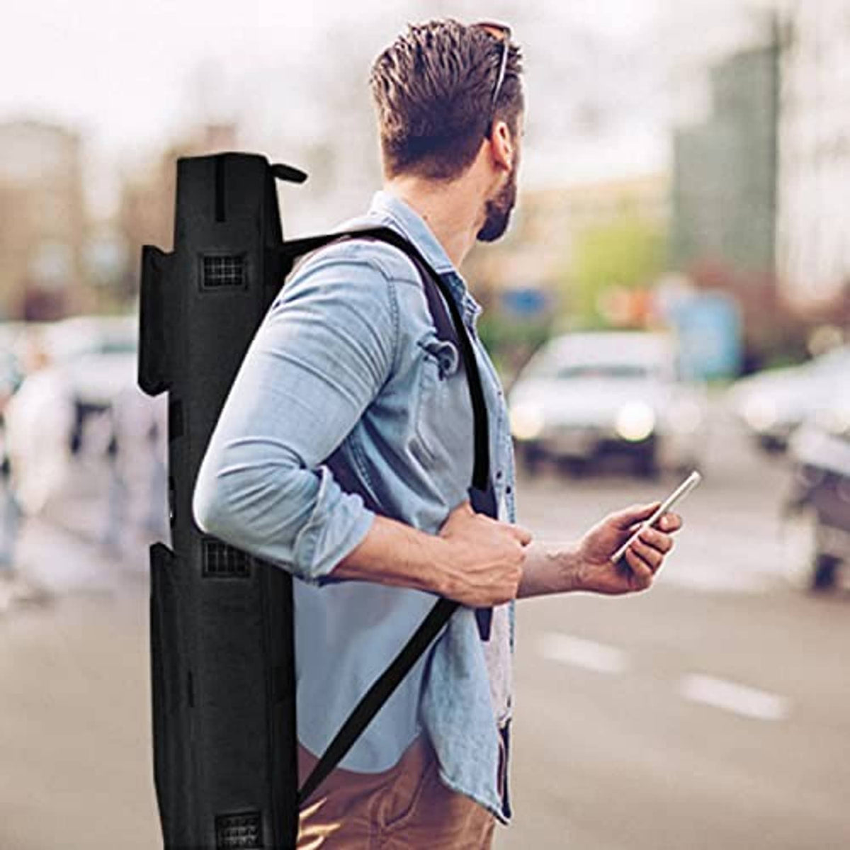 Man carrying a black pool cue case on the shoulder with adjustable strap