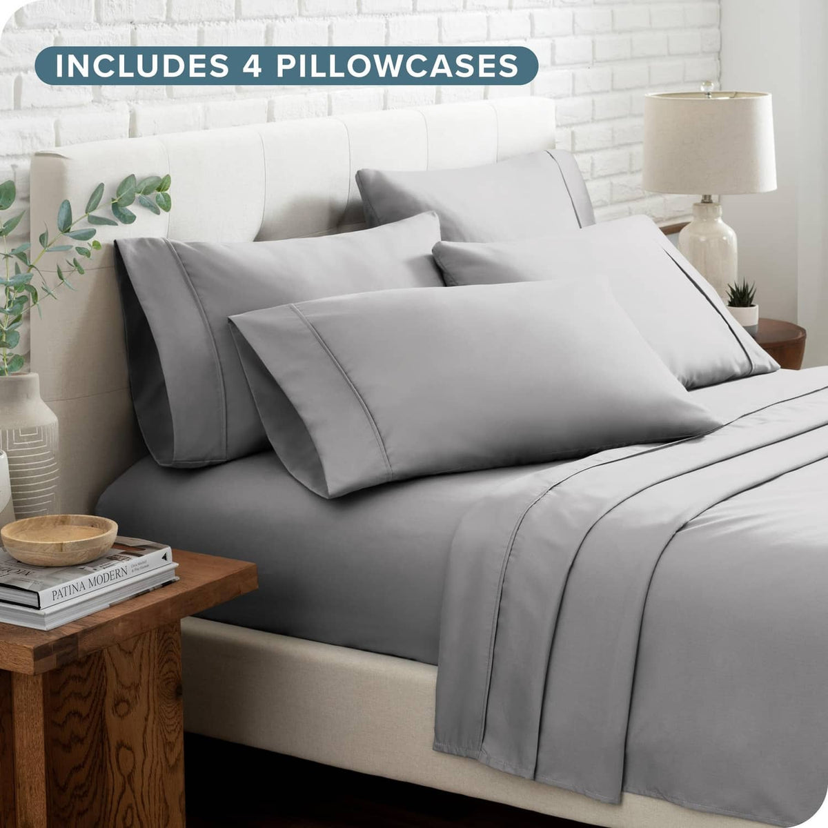 Light grey queen bed linen set with pillowcases and neatly folded sheets