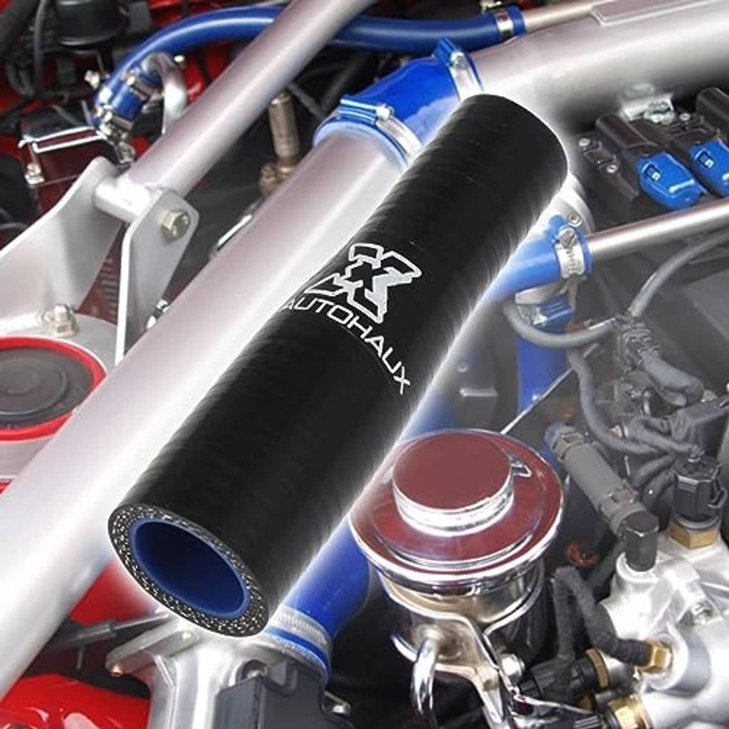 Black rubber hose reducer with blue inner opening installed on an engine