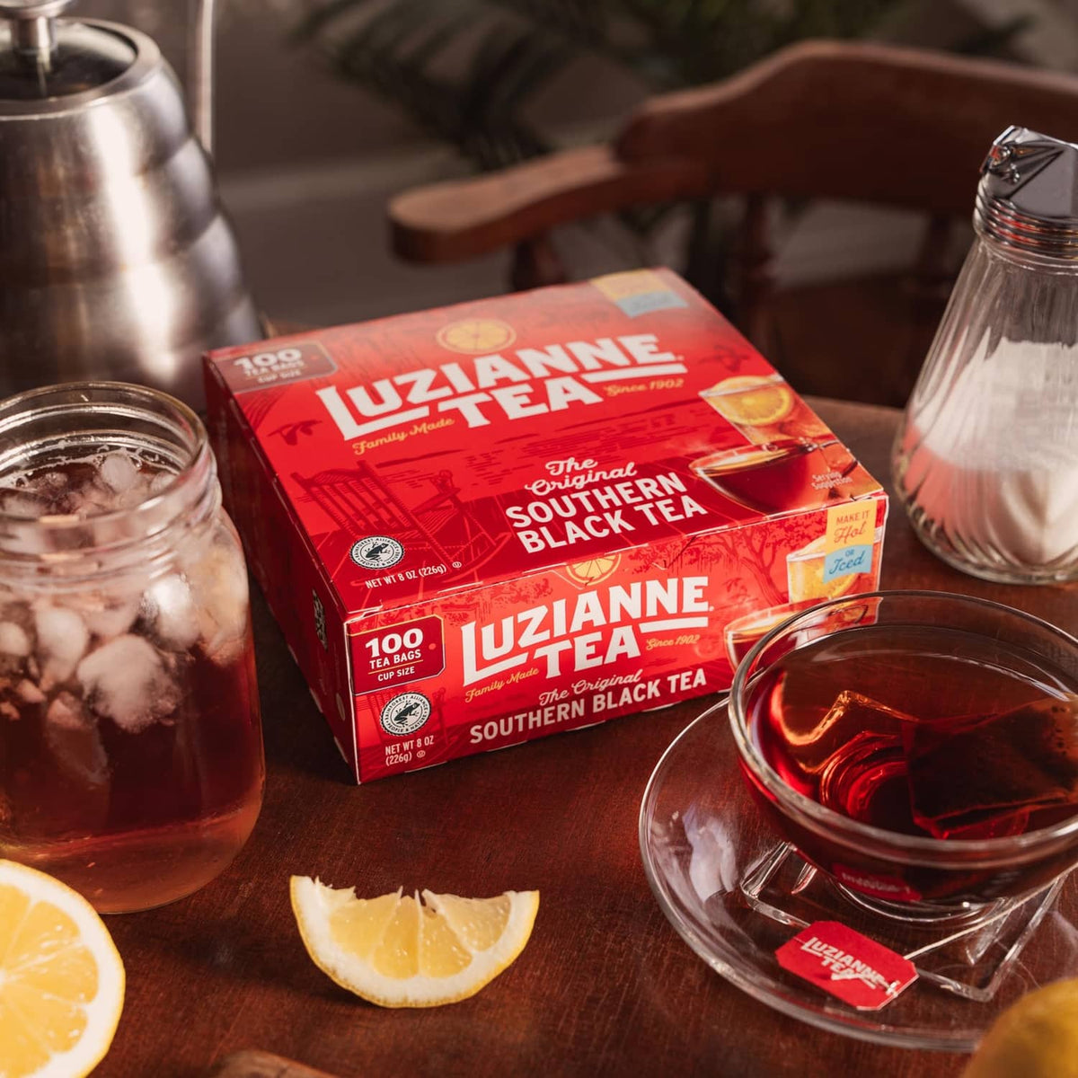 Luzianne Southern Black Tea iced tea bag box with lemon slices on table