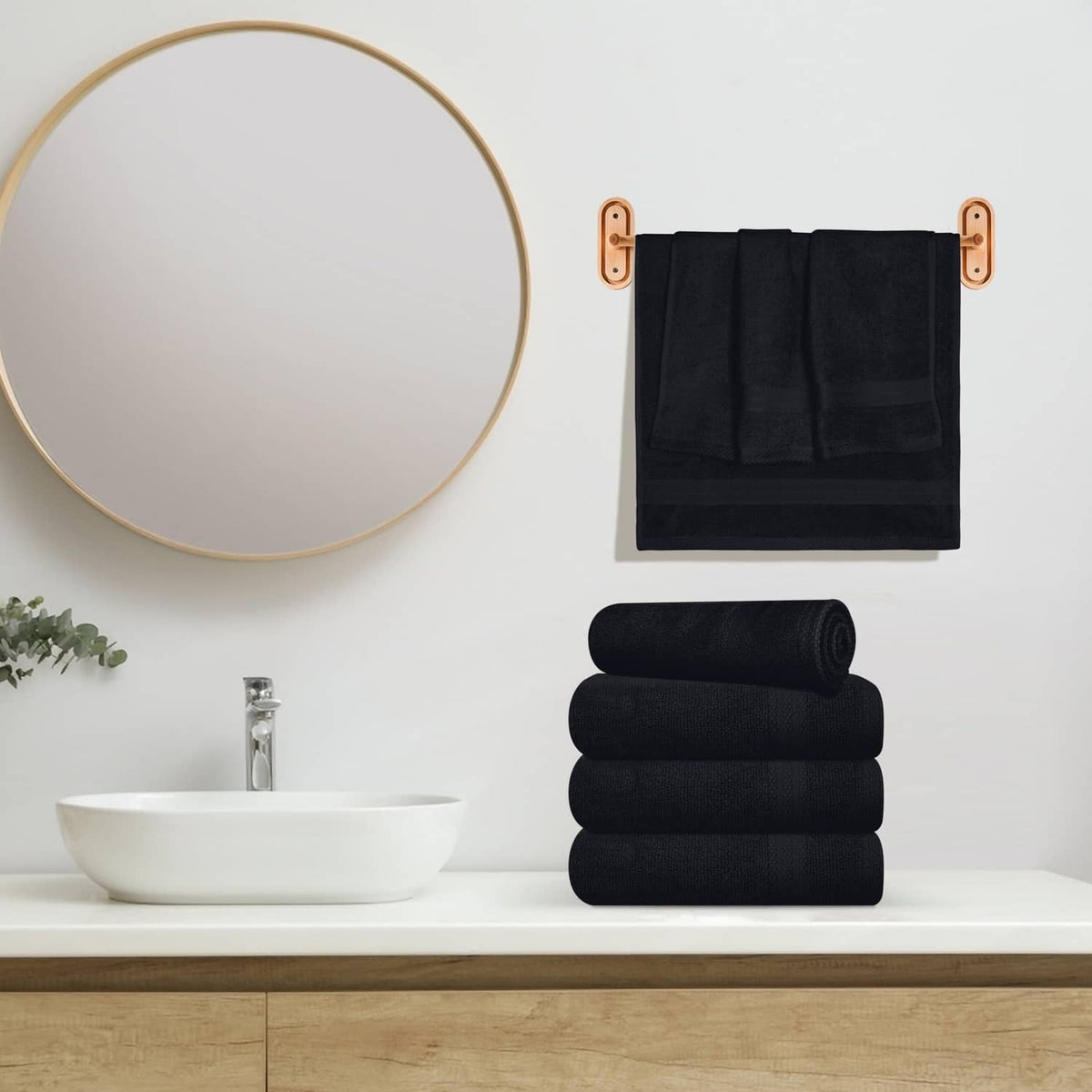 Black hand towel set with folded towels on a countertop
