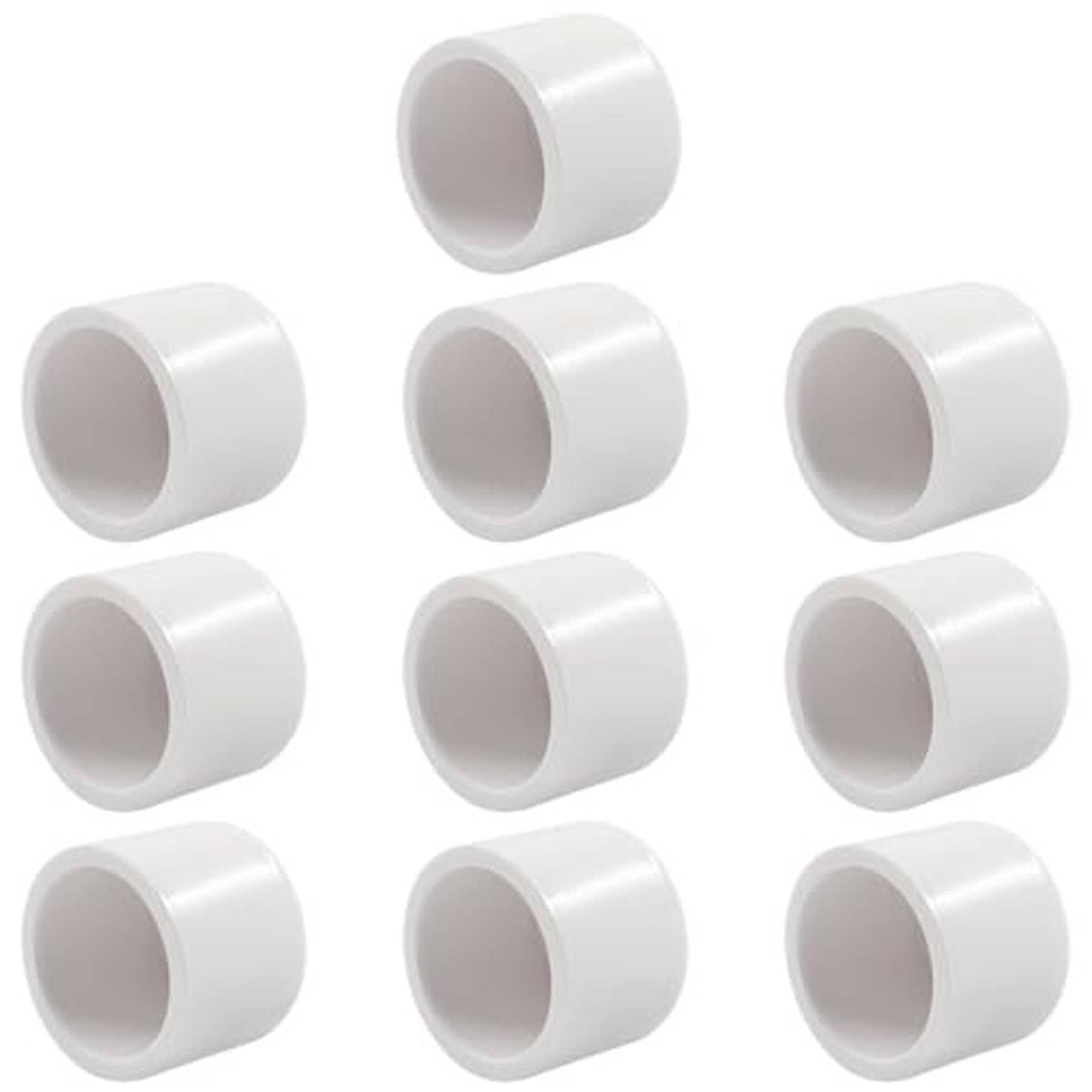 Multiple white PVC pipe end caps, open ends facing forward